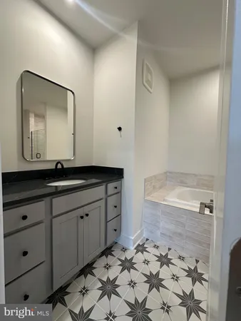 a bathroom with a sink a mirror and a shower
