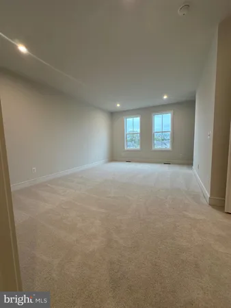 a view of an empty room with windows