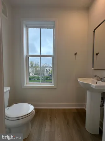 a white toilet sitting next to a bathroom sink
