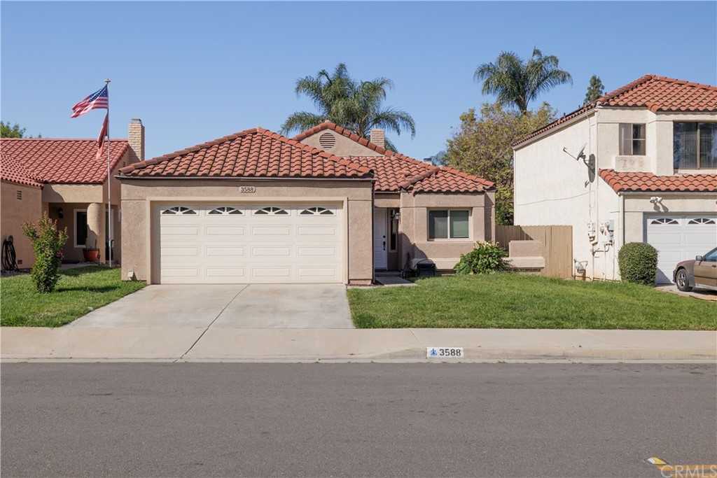 3588 Atchison Circle Riverside, CA 92503 - Photo 1 of 1 a front view of a house with a yard and garage