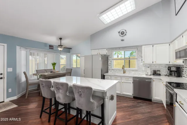 a large kitchen with a table and chairs in it