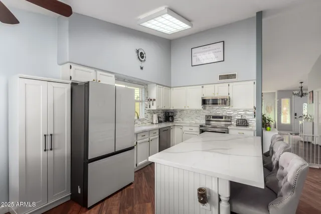 a kitchen with stainless steel appliances a refrigerator sink and stove