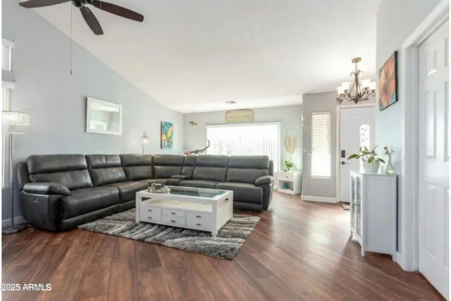 a living room with furniture and a chandelier