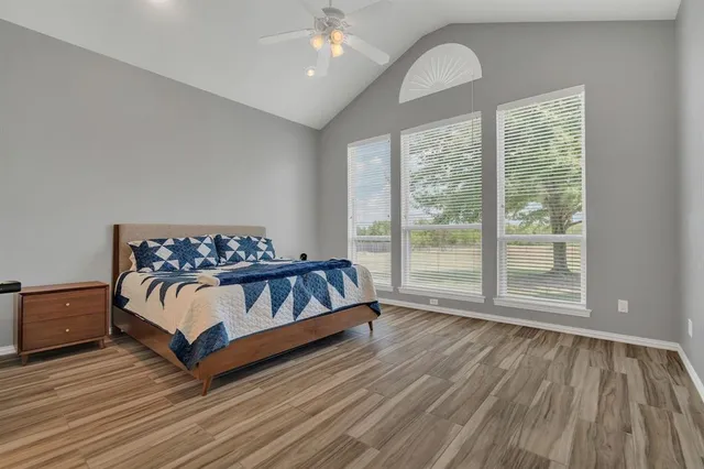 a bedroom with a bed and a large window