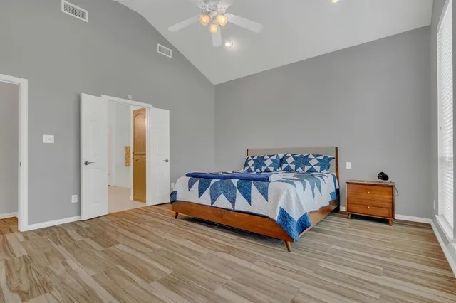 a bedroom with a bed and lamp