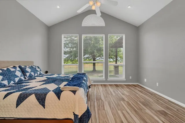 a bedroom with a bed and wooden floor