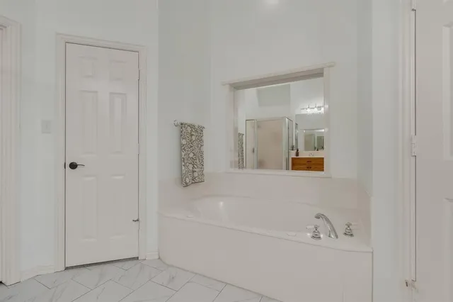 a white bath tub sitting next to a white sink