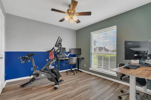 a view of a workspace with furniture and a window