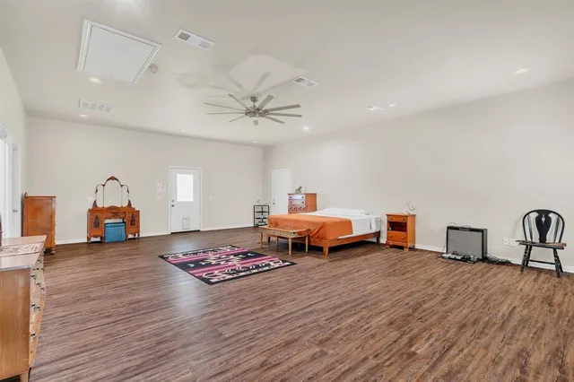 a bedroom with furniture and a wooden floor
