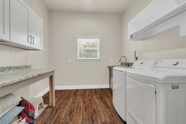a utility room with sink dryer and washer