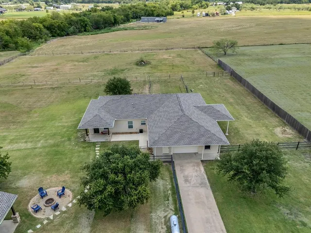 a aerial view of a house with a yard lake view and mountain view