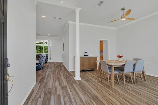 a view of a dining room with furniture and wooden floor