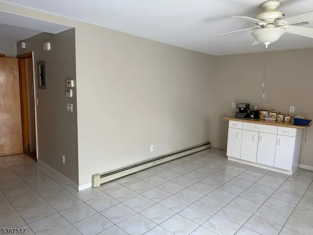 an empty room with cabinets and a kitchen