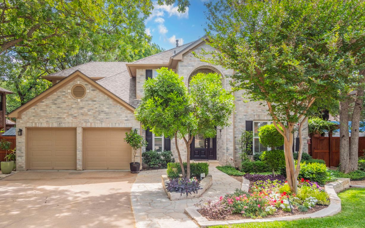 a front view of a house with garden