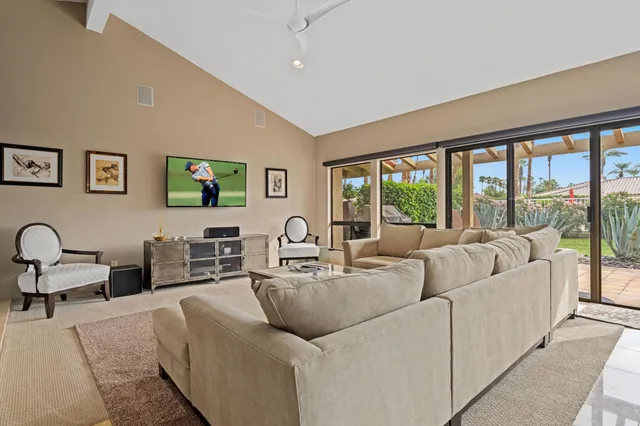 a living room with furniture and large windows