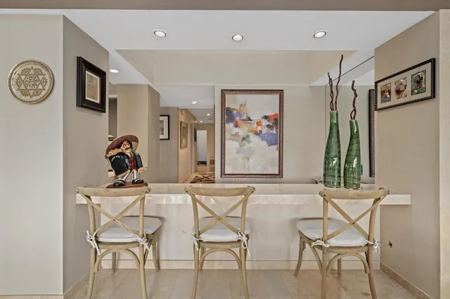 a view of a dining room with furniture and a kitchen