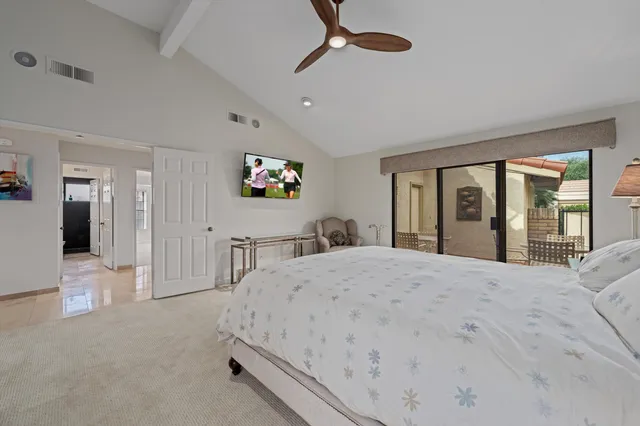 a bedroom with a bed and a large window