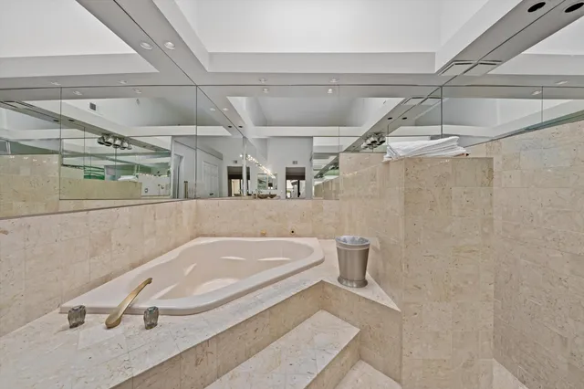 a bathroom with a tub and shower