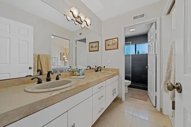 a bathroom with a double vanity sink and mirror