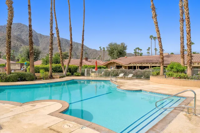 a view of a swimming pool and trees in the background