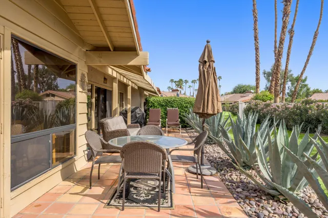 a view of a patio with a table and chairs