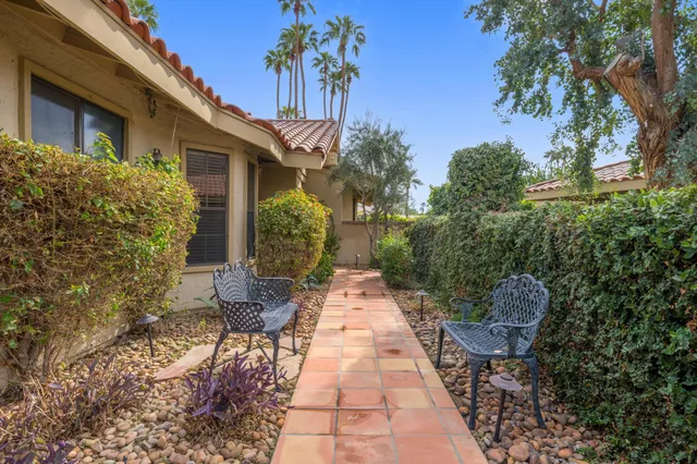 a view of a chairs and table in backyard of the house