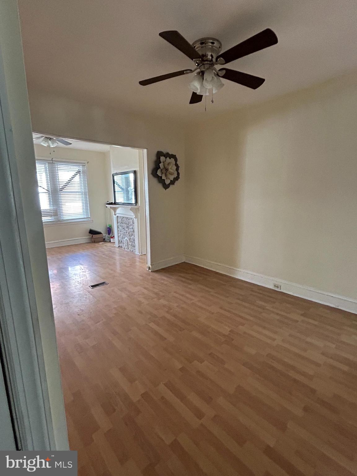 5622 Appletree Street Philadelphia, PA 19139 - Photo 3 of 10 en empty room with wooden floor and ceiling fan