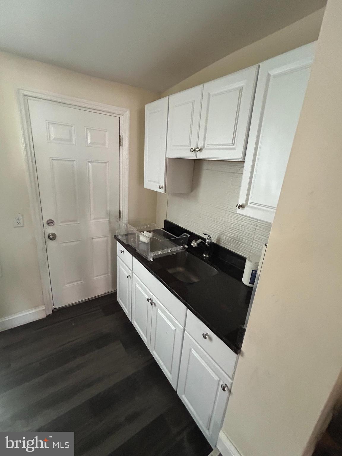 5622 Appletree Street Philadelphia, PA 19139 - Photo 4 of 10 a kitchen with granite countertop a sink and a stove top oven