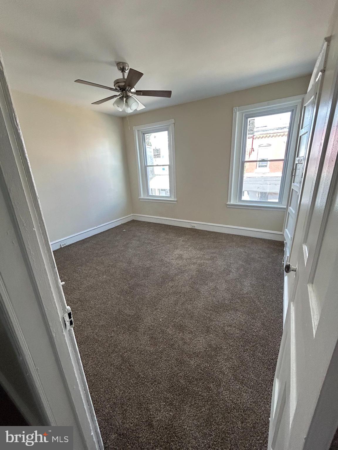 5622 Appletree Street Philadelphia, PA 19139 - Photo 7 of 10 a view of a livingroom with a window and a ceiling fan
