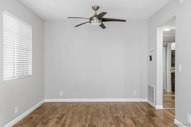 a view of room with a ceiling fan and window