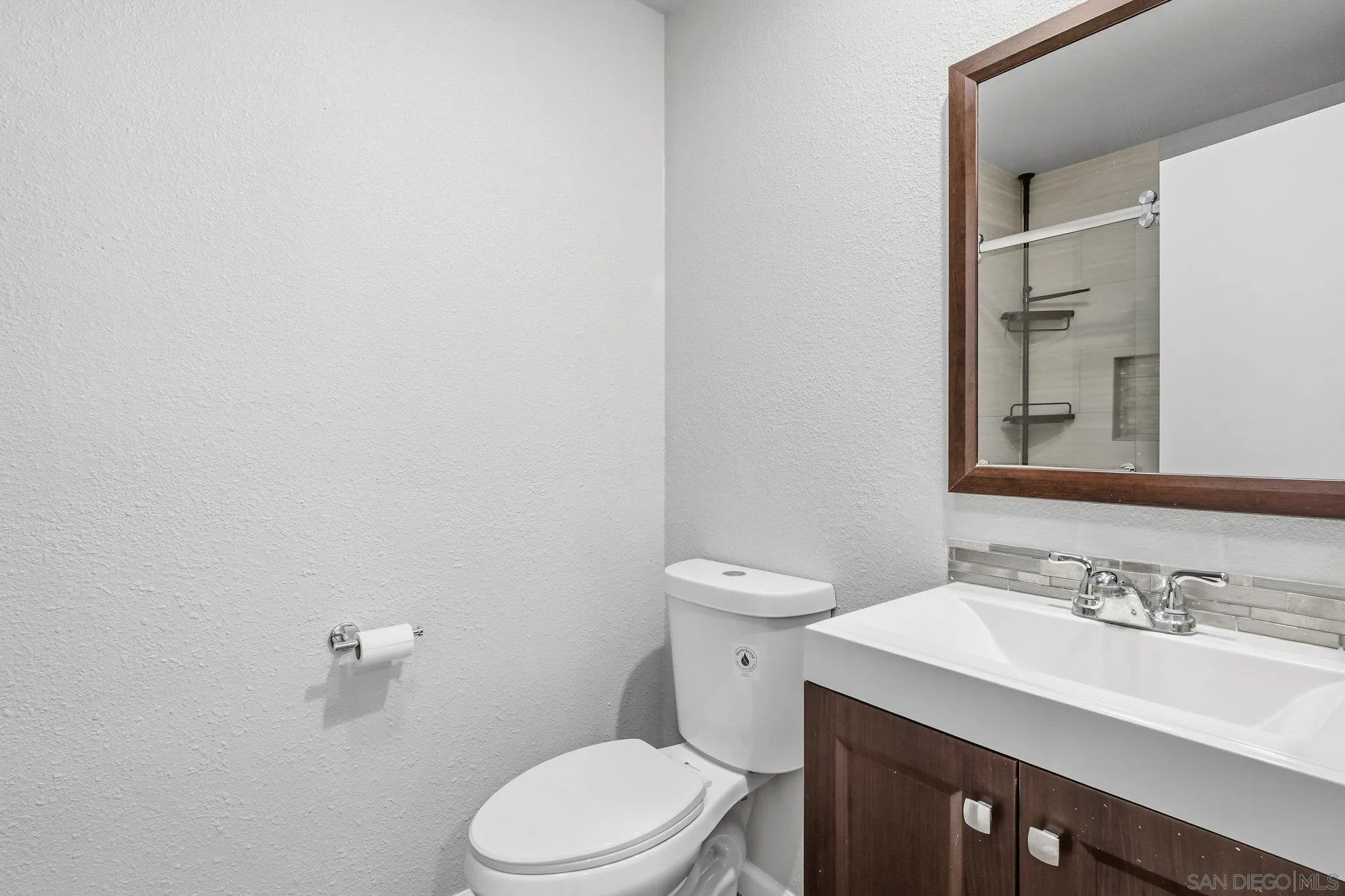 774 Eastshore Terrace, Unit 169 Chula Vista, CA 91913 - Photo 19 of 34 a bathroom with a sink a toilet and a mirror