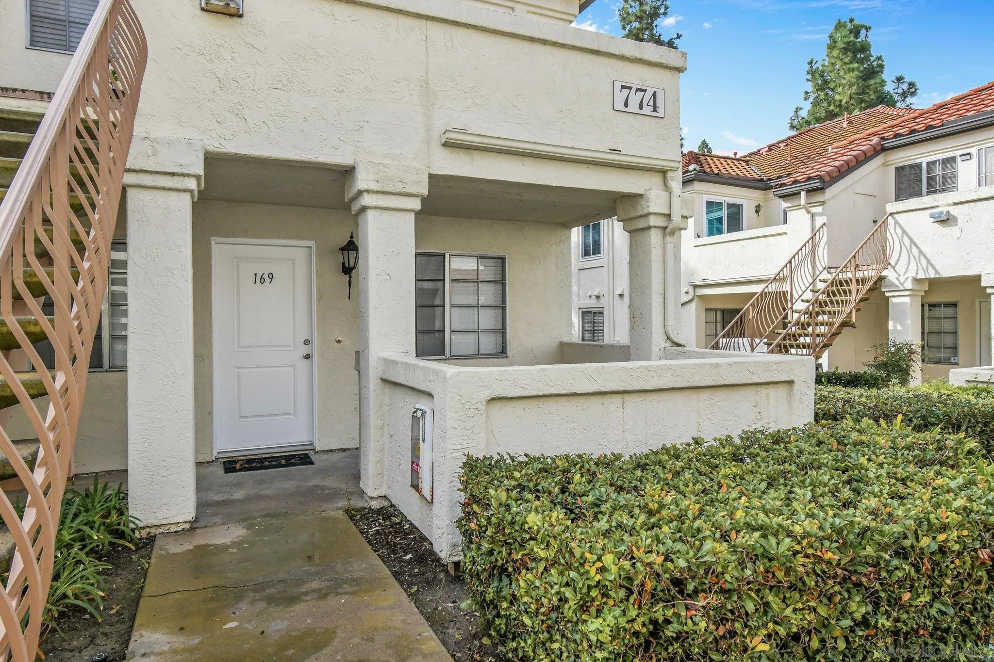 774 Eastshore Terrace, Unit 169 Chula Vista, CA 91913 - Photo 2 of 34 a front view of a house with a garden