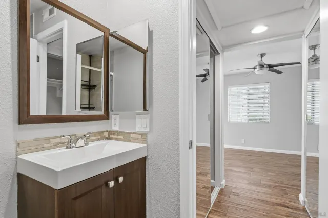 a bathroom with a sink mirror and shower