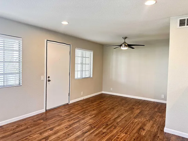 wooden floor in an empty room with a window