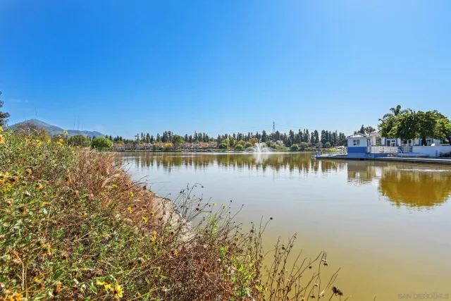 a view of a lake with houses in the background