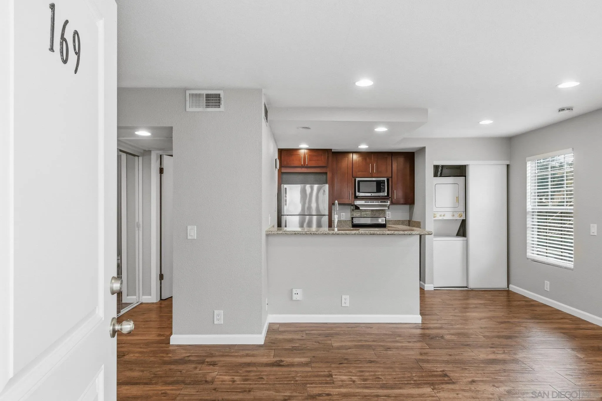 774 Eastshore Terrace, Unit 169 Chula Vista, CA 91913 - Photo 4 of 34 a kitchen with stainless steel appliances granite countertop a refrigerator and a stove top oven
