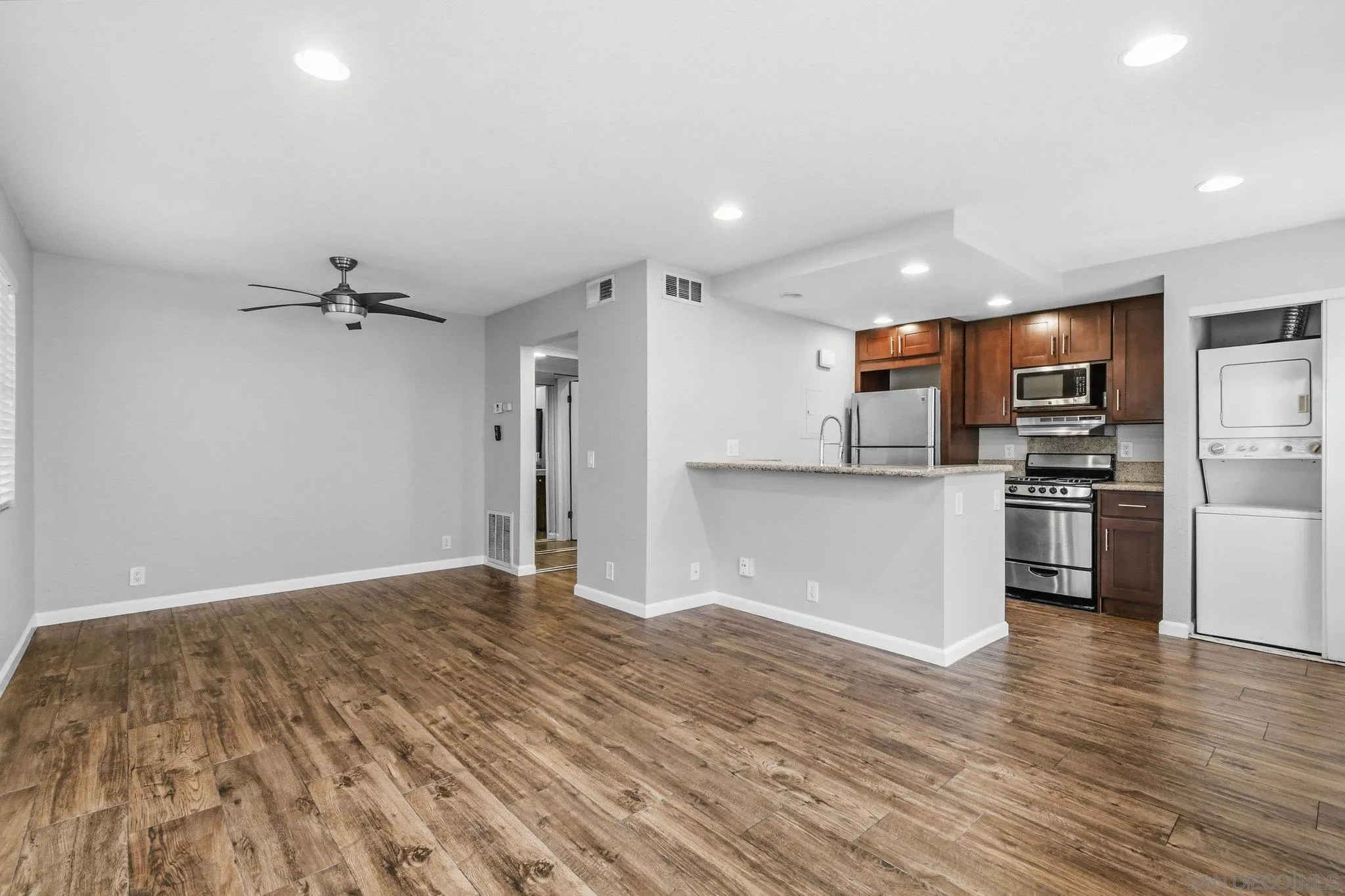 774 Eastshore Terrace, Unit 169 Chula Vista, CA 91913 - Photo 7 of 34 a view of a kitchen with a sink and a refrigerator