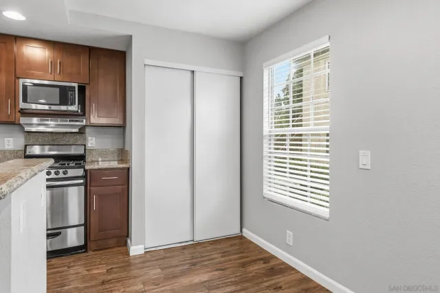 a kitchen with a refrigerator and a stove top oven