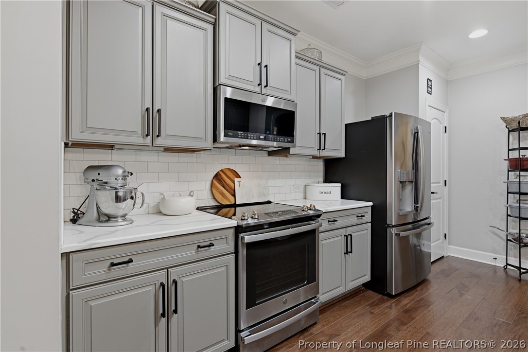 148 Heatherspring Way Spring Lake, NC 28390 - Photo 19 of 50 a kitchen with stainless steel appliances granite countertop a stove a refrigerator and a microwave