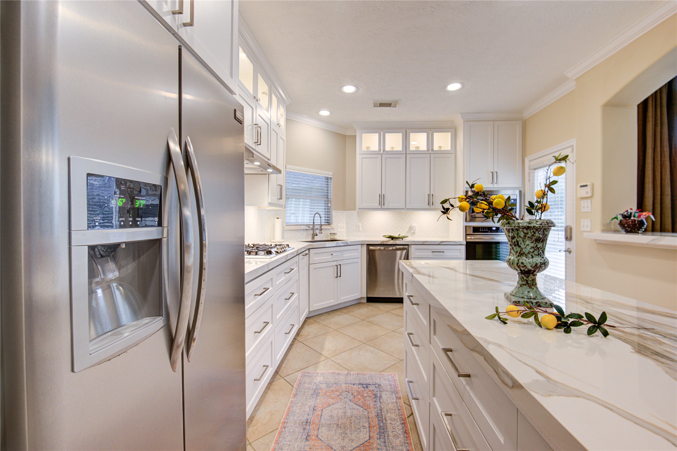 7207 Fiesta Flower Katy, TX 77494 - Photo 5 of 37 Bright and open, this fully renovated kitchen highlights clean shaker-style cabinets paired with luxurious quartz countertops for a timeless design.