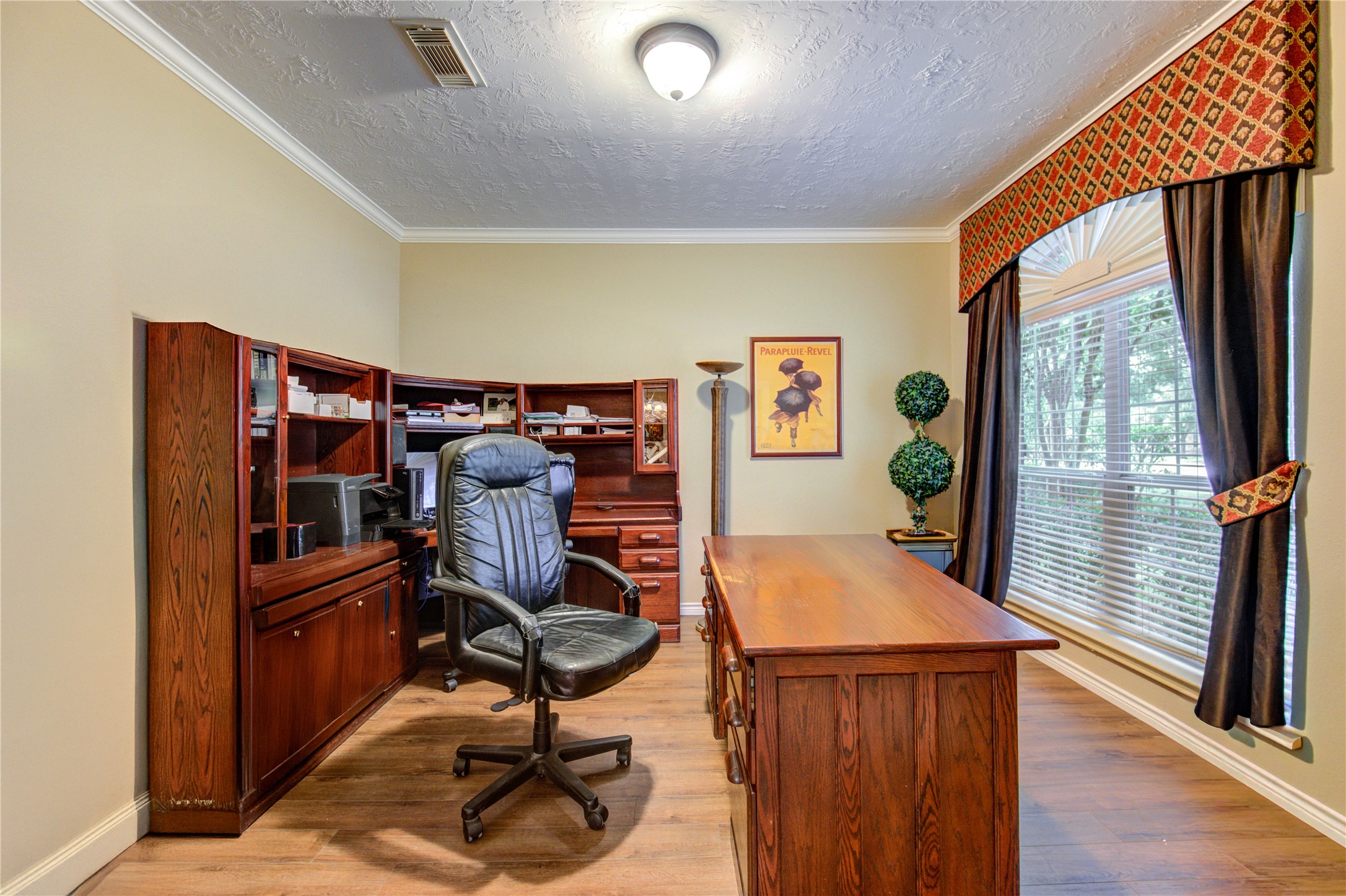 7207 Fiesta Flower Katy, TX 77494 - Photo 8 of 37 Light-filled room currently used as a home office, ideal for remote work or a dedicated study area. The wood look tile flooring and clean, neutral palette allow for a seamless transition to a playroom, music room, or guest space if desired.