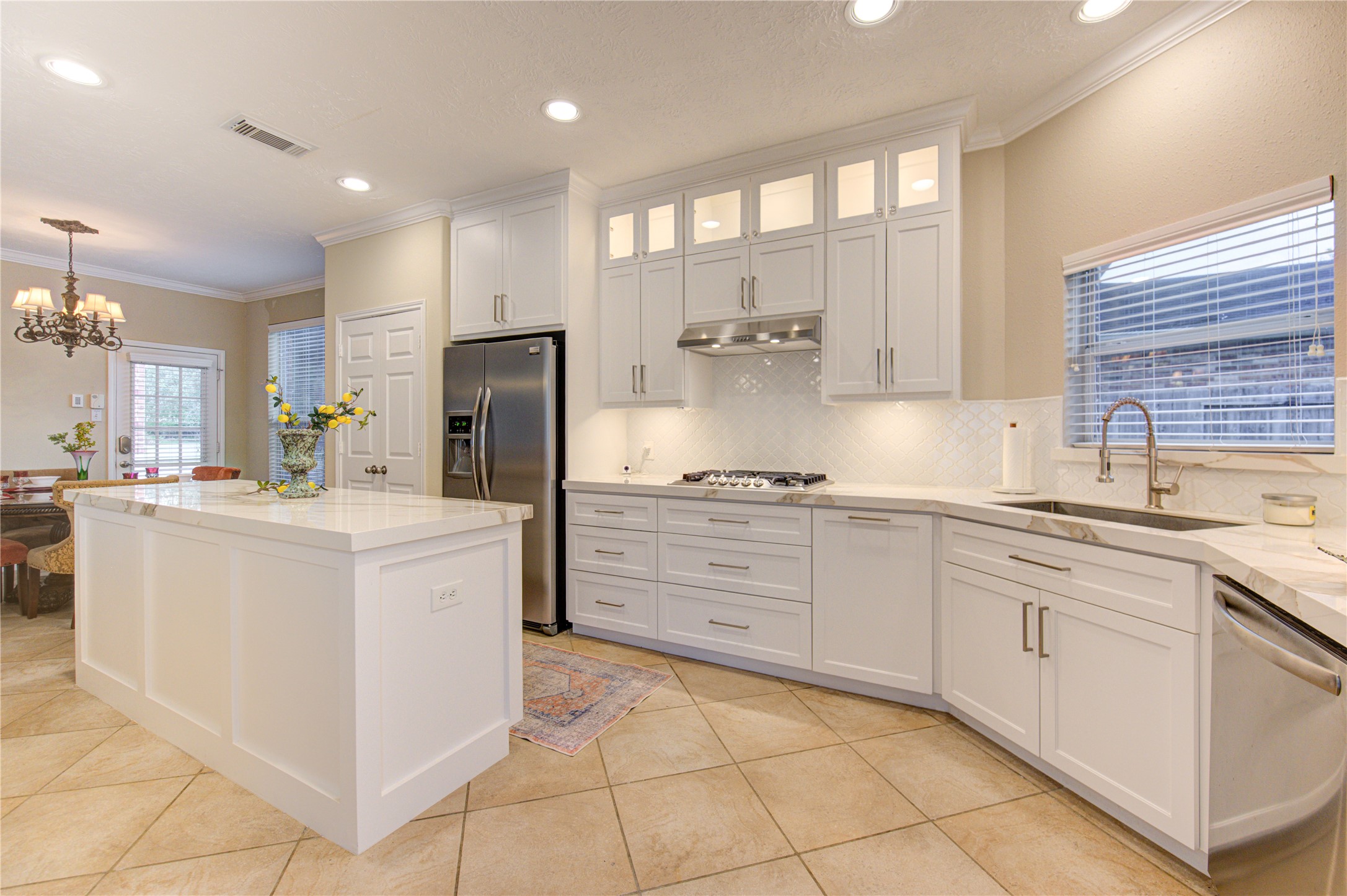 7207 Fiesta Flower Katy, TX 77494 - Photo 9 of 37 true showpiece featuring crisp white cabinetry, gleaming Quartz counters, stainless steel appliances, and an oversized serving bar—perfect for buffet-style entertaining or casual dining.