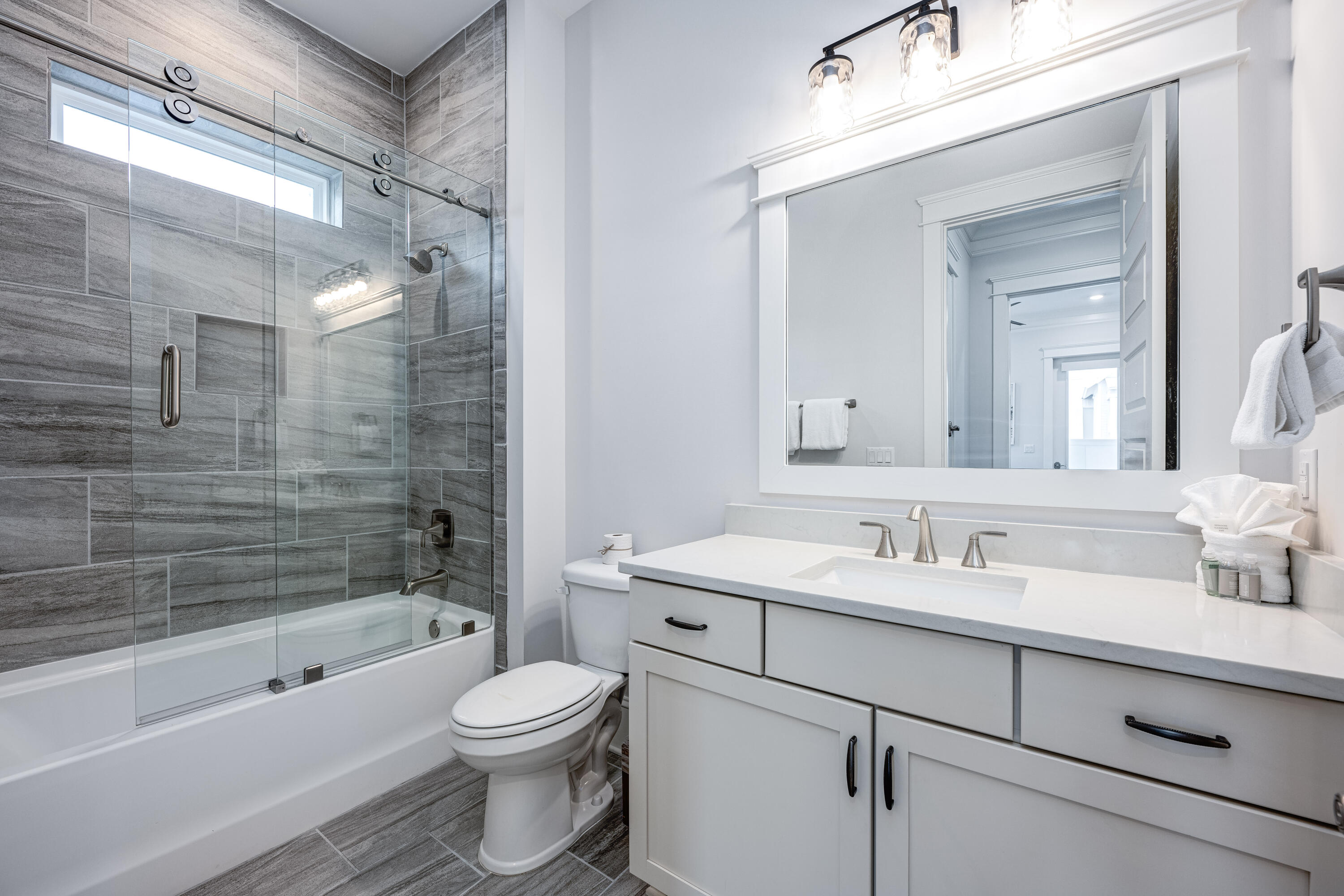 161 Siasconset Ln Inlet Beach Inlet Beach, FL 32461 - Photo 23 of 46 a bathroom with a toilet a sink a mirror a bathtub and shower