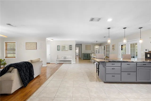 a large kitchen with a large counter top appliances and cabinets