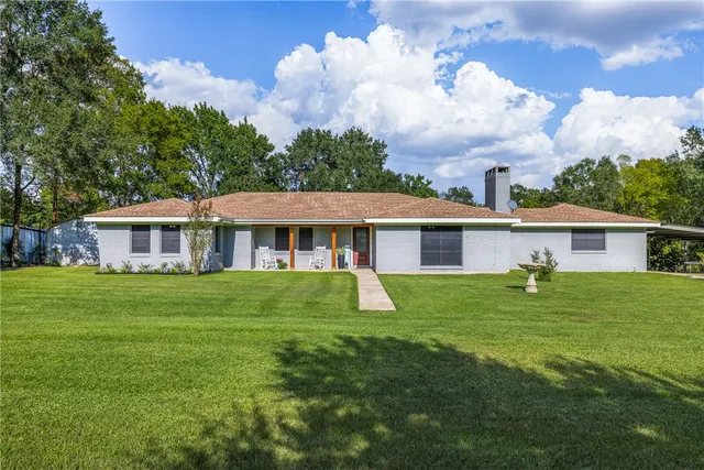 a backyard of a house with table and chairs