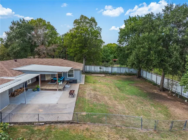 a view of a house with a backyard and sitting area