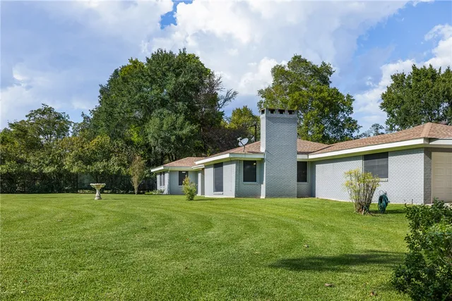 a front view of house with yard and green space