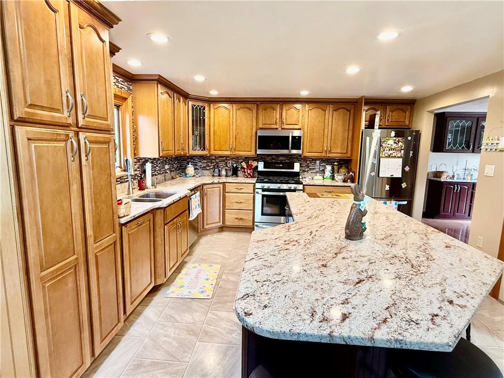 198 Leslie Road Valencia, PA 16059 - Photo 15 of 43 a large kitchen with stainless steel appliances kitchen island granite countertop a sink and cabinets