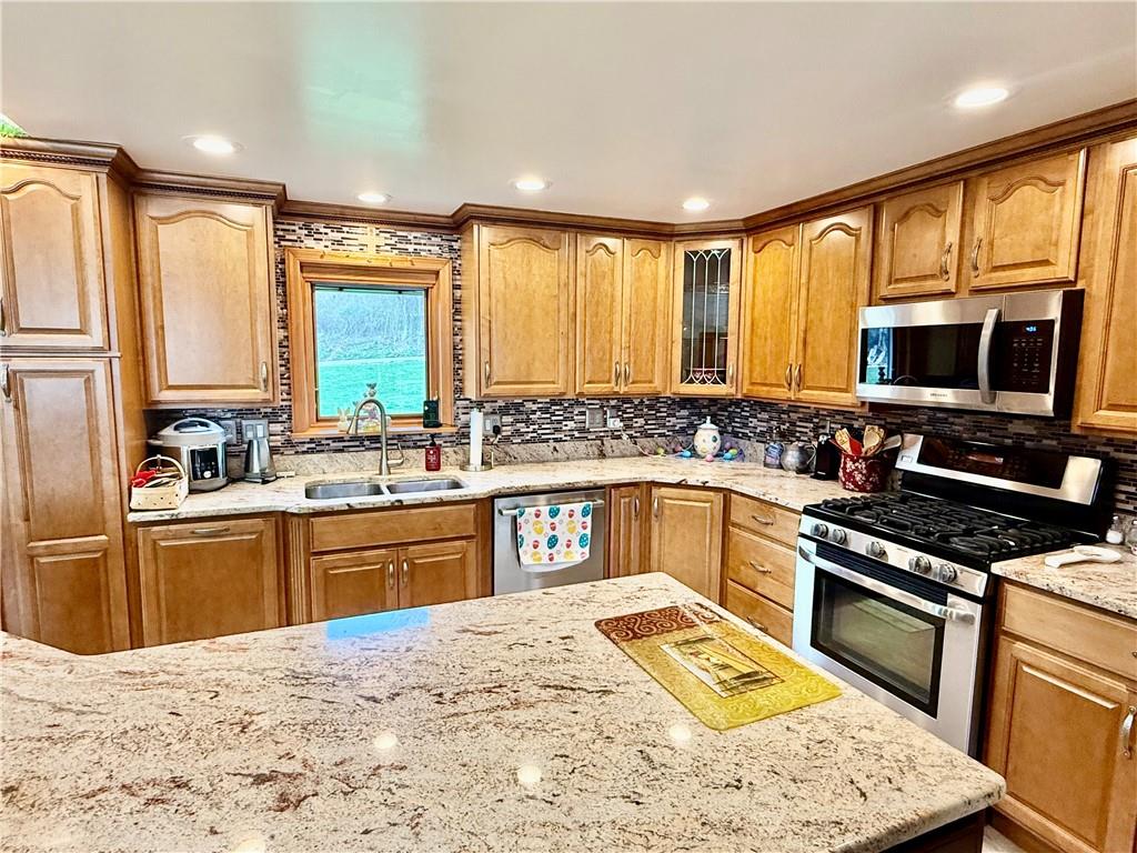 198 Leslie Road Valencia, PA 16059 - Photo 16 of 43 a kitchen with stainless steel appliances granite countertop a sink stove and refrigerator