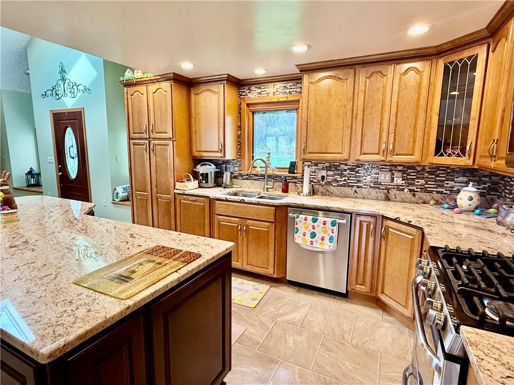 198 Leslie Road Valencia, PA 16059 - Photo 18 of 43 a kitchen with stainless steel appliances granite countertop a stove a sink and a refrigerator